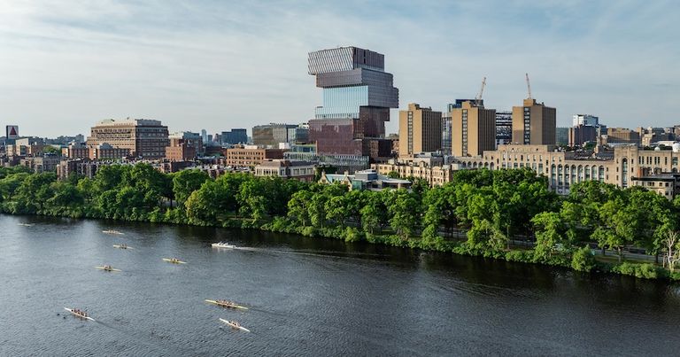 The Boston University skyline featuring the Computer & Data Science building, the Charles River appears in the foreground with several boats.